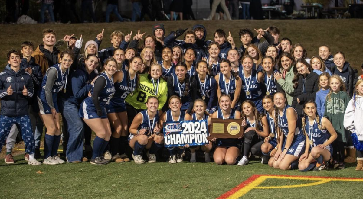 Shepaug field hockey's team celebrates with their fans after its 1-0 state championship win Nov. 16. (Courtesy of Miles Wilson)